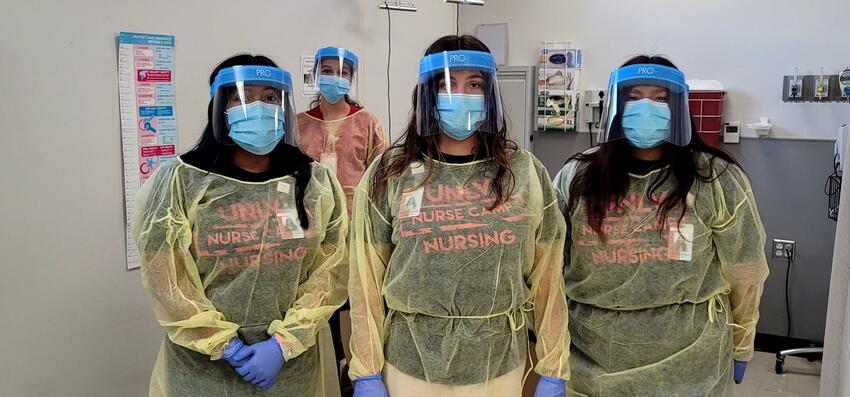 Three nursing camp participants dressed in personal protective equipment.