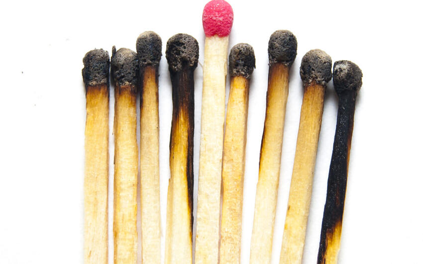 Burnt-out matches surrounding one unlit match