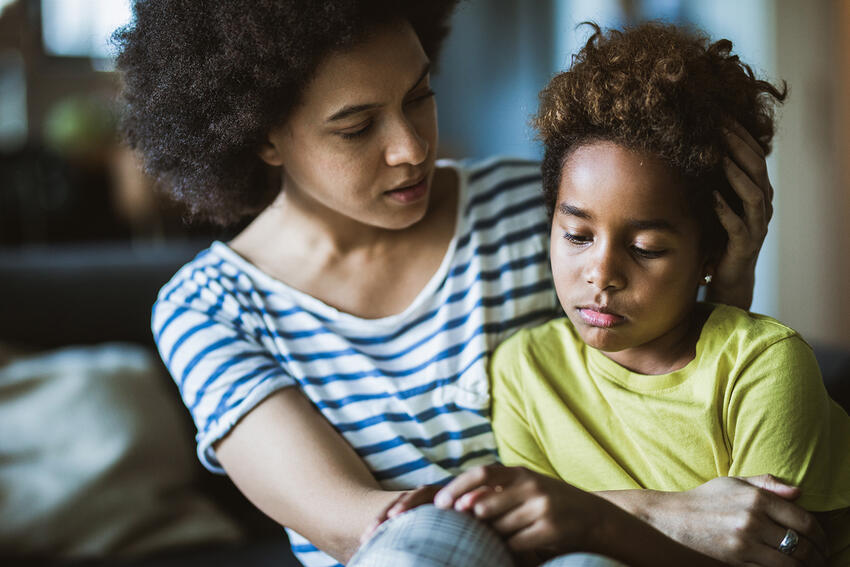 Mother supporting a grieving child