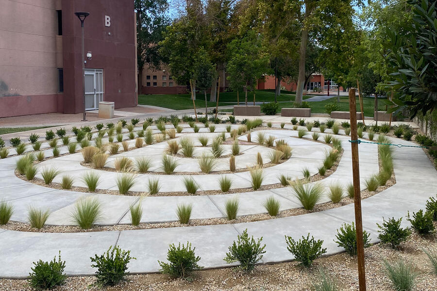 Circular labyrinth with a trail with small rock border