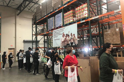 A group of people lining up at a warehouse