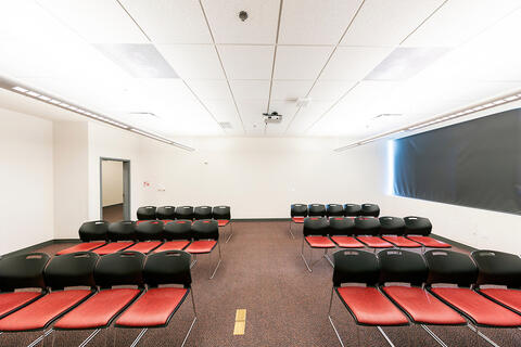 A meeting room with three rows of chairs