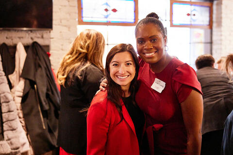 Two women side hugging each other