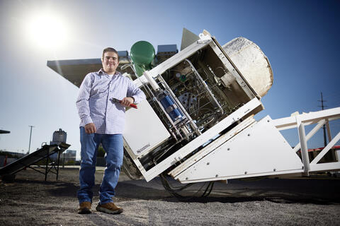 A student standing in front of an object