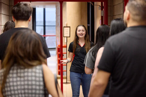 A student leader speaks to a group of people.