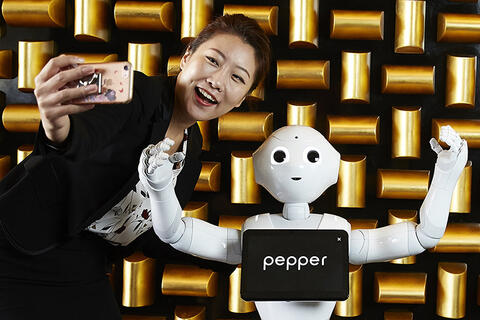 Woman taking a selfie with a robot
