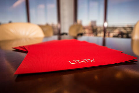 A stack of UNLV red documents.