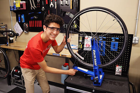 A student fixing a bicycle