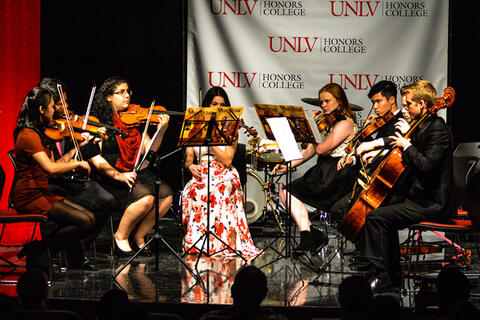 Multiple students playing the violin
