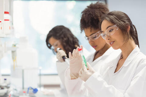 Three students doing lab work