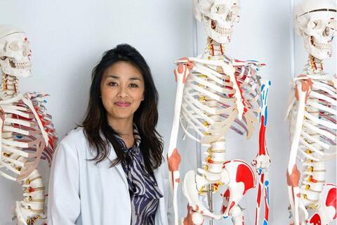Researcher poses with skeletons