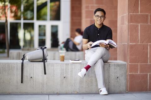 Student sitting with textbook